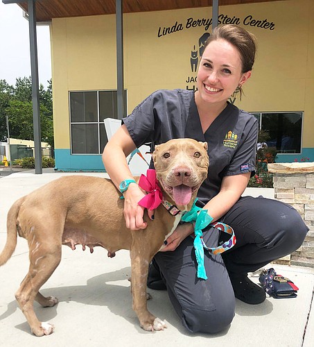 Lauren Snyder, veterinary services coordinator at the Jacksonville Humane Society, with her adopted dog, Baby Girl.