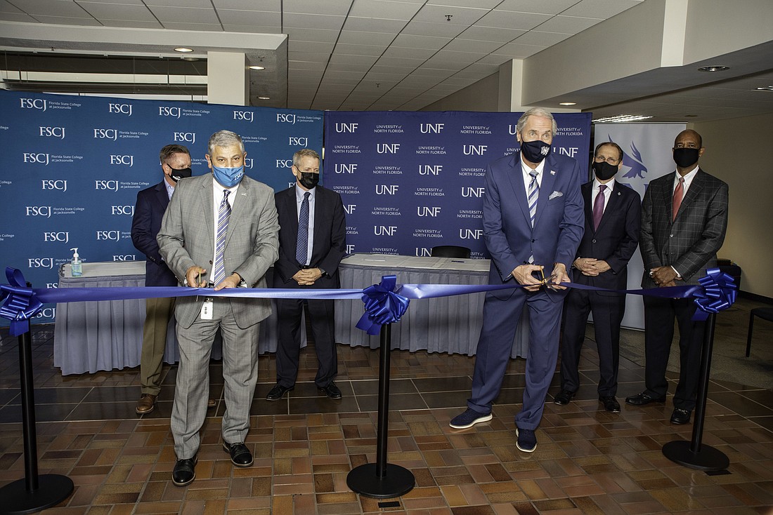 UNF President David Szymanski and FSCJÂ President John Avendano cut the ribbon at the opening of the UNF MedNexus and FSCJ partnership, joined by Mike Bell, state Rep. Paul Renner, Kevin Hyde and Wayne Young.