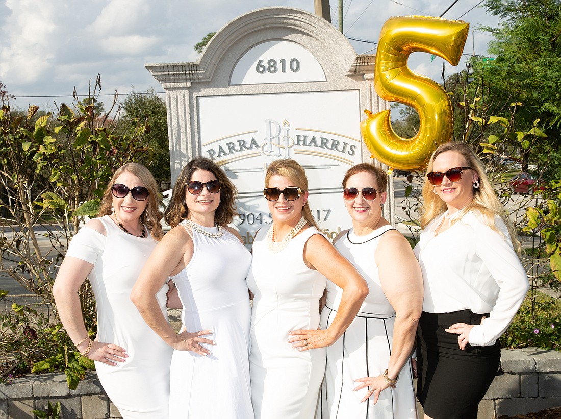 The Paola Harris Law firm is celebrating its anniversary. From left, paralegal Christina Tisdale, attorney Mercedes Blason-Aguilar, founder Paola Parra Harris, attorney Priscilla Justiniano and Ashley Conklin, legal assistant.