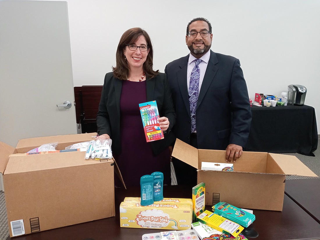 Law Week Committee Co-chairs Mary Margaret Giannini and David Thompson with art supplies donated by Jacksonville Bar Association members.
