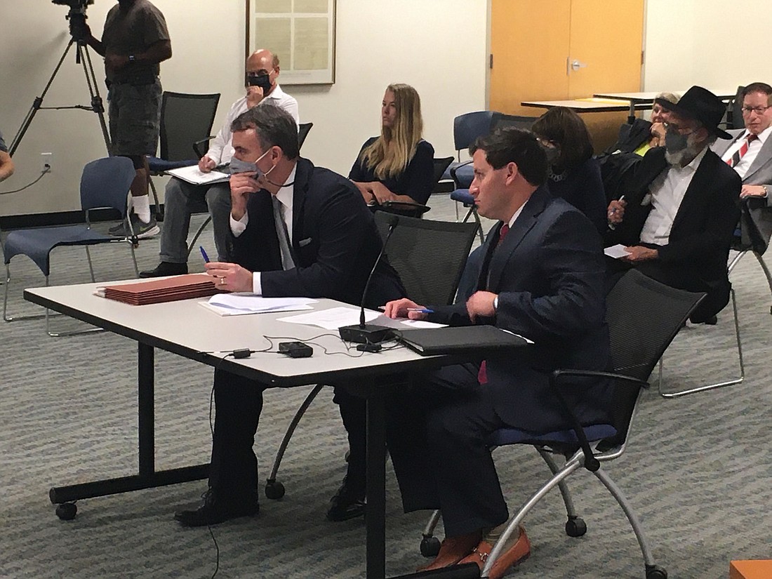 Rogers Towers attorney Wyman Duggan (left) and Matt Harris discuss rezoning for the proposed Time Out Sports Grill Mandarin before the Planning Commission on May 6.