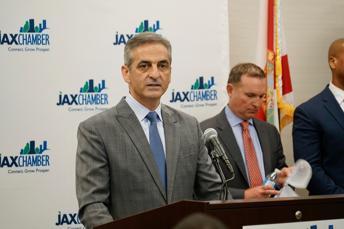 Dun & Bradstreet CEO Anthony Jabbour announces the move of the company to Jacksonville May 20. At right is Jacksonville Mayor Lenny Curry.