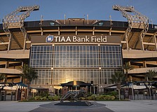 Jacksonville Jaguars fans tailgate with a Christmas tree and a doll of  Jaguars owner Shad Khan in the parking lot of EverBank Field before an NFL  football game against the Tennessee Titans