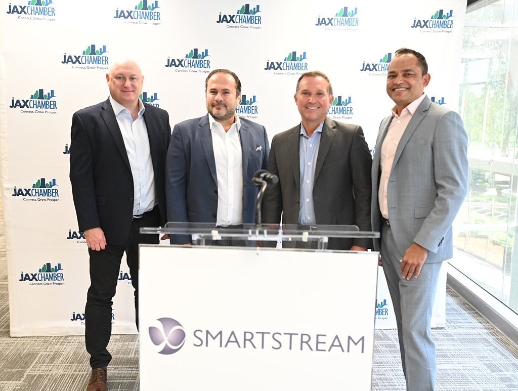 SmartStream executives, from left, Nick Smith, executive vice president; Haytham Kaddoura, CEO; Jacksonville Mayor Lenny Curry; and Bharat Malesha, executive vice president.