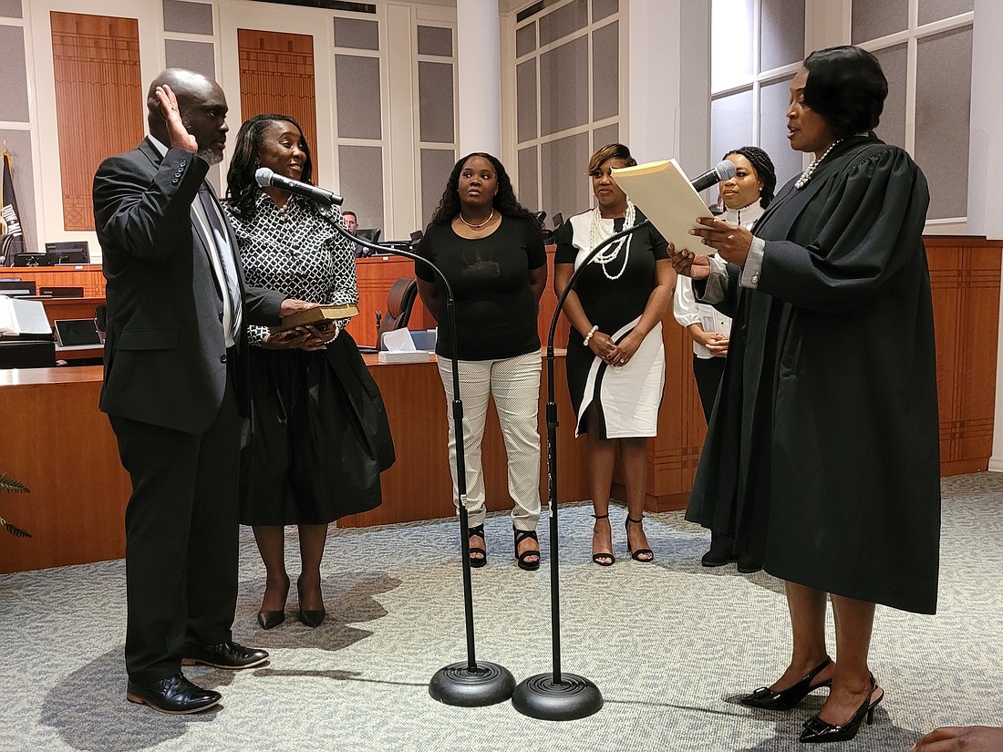 Sam Newby is sworn in as City Council president by Judge Rhonda Peoples-Waters. Newbyâ€™s wife, Sheila Newby, holds the Bible. Witnessing are his daughters Audrey Newby, Brittani Whipple, Ashley Newby and Kanisha Lowe (not shown).