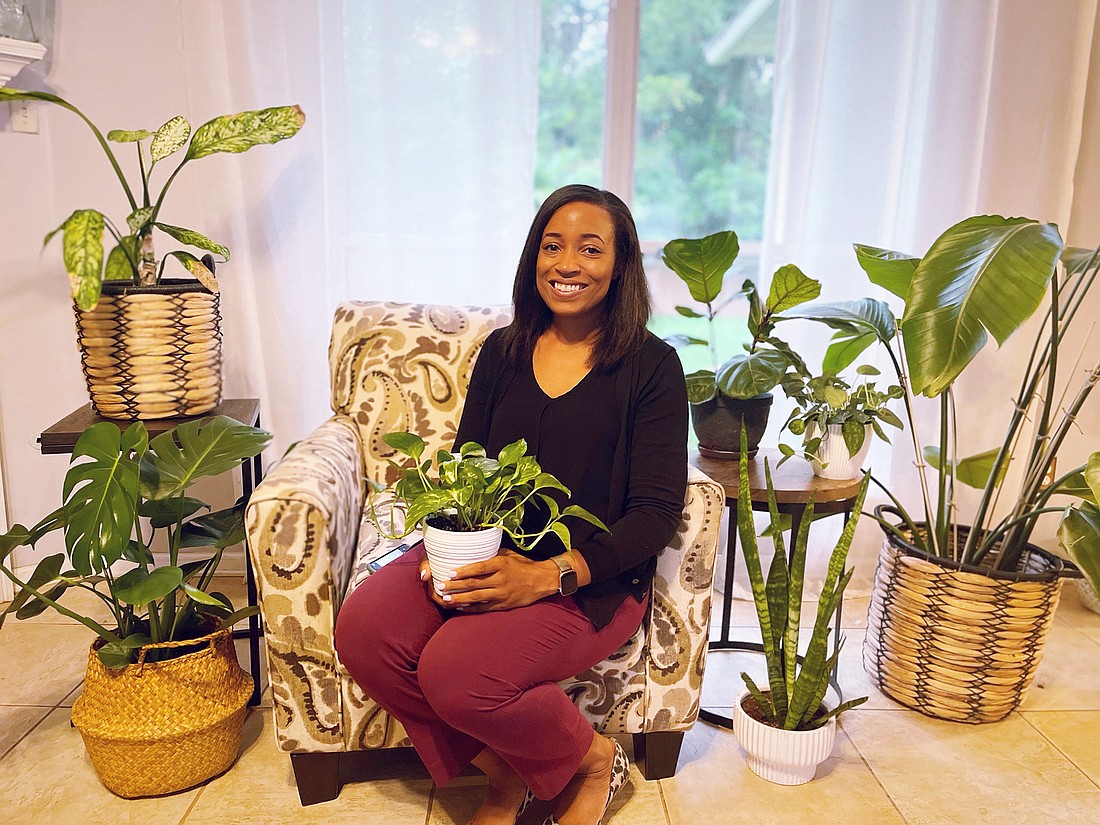 Assistant Clay County Attorney Cassandra Smith shows off her collection of plants she started growing at home during the COVID-19 pandemic.