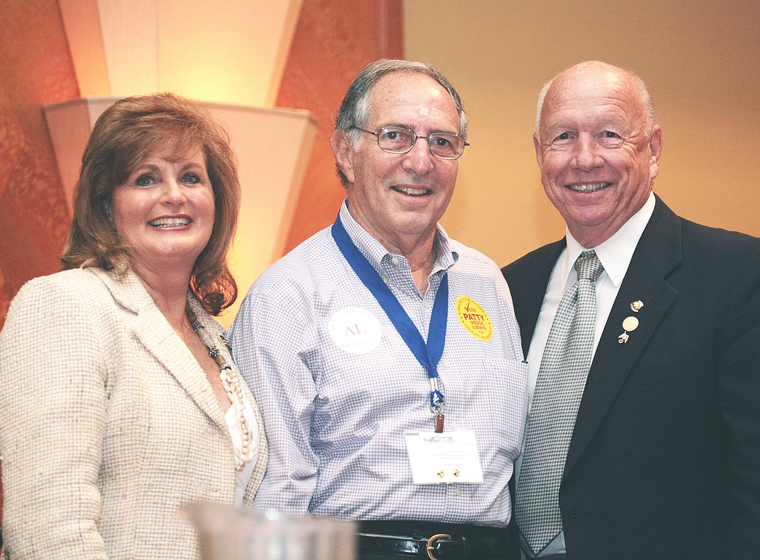 Arnold Tritt (center) with Merchandising Plus owner Rita Williams and former Florida Home Builders Association president Paul Mashburn at an FHBA Hall of Fame ceremony.