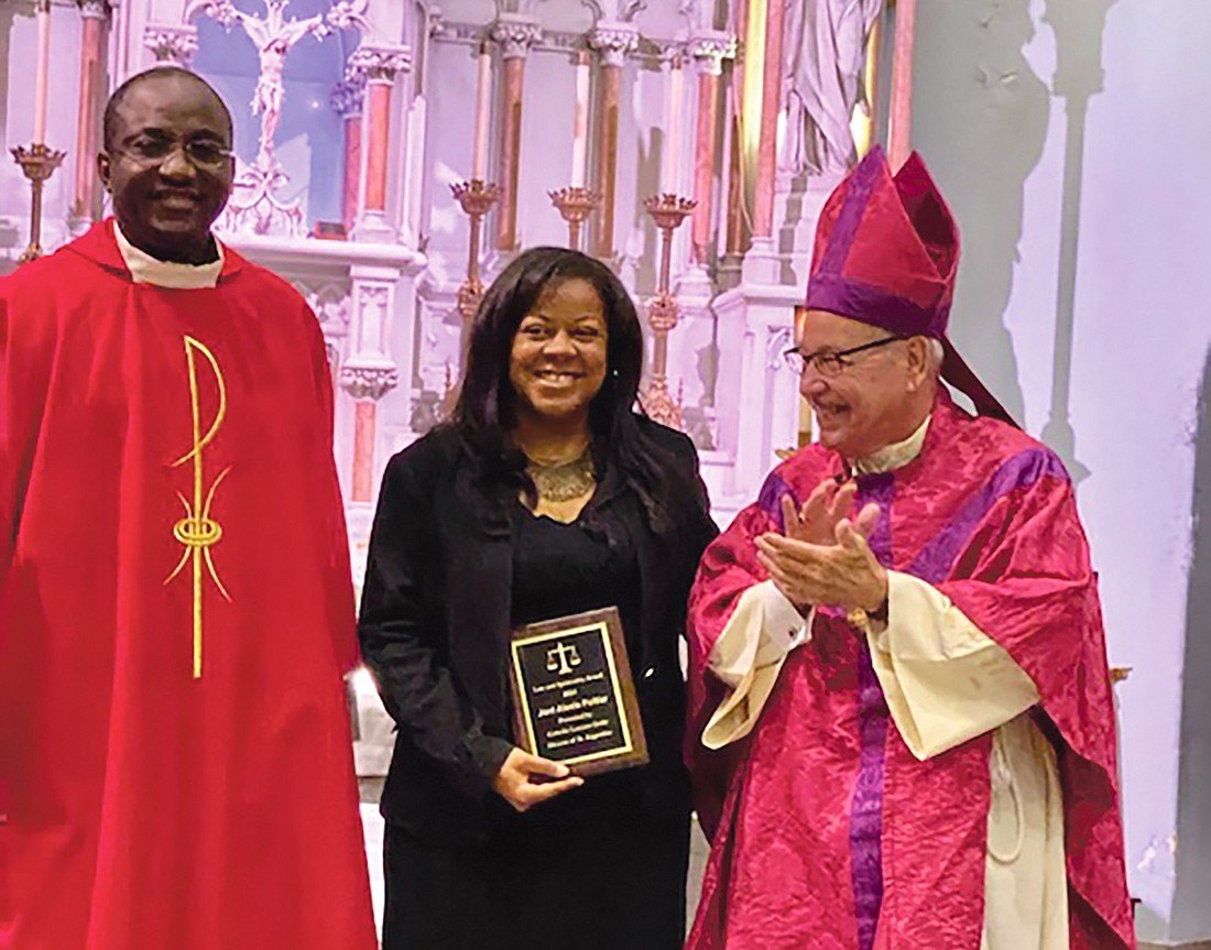 Judicial Vicar Fr. Peter Akin-Otiko, attorney Joni Poitier with the 2021 Law & Spirituality Award and Bishop Felipe Estevez of the Diocese of St. Augustine.