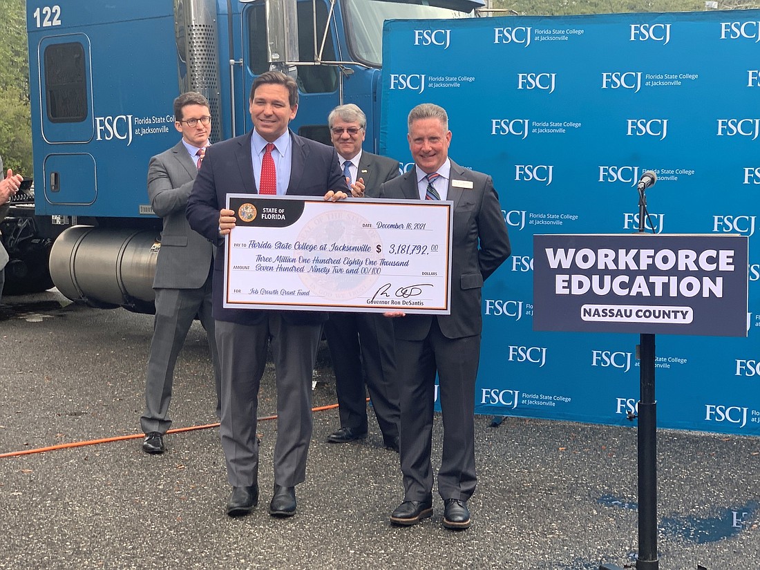 From left, Florida Department of Economic Opportunity Secretary Dane Eagle, Gov. Ron DeSantis, Florida Department of Transportation Secretary Kevin Thibault and Florida State College at Jacksonville board Chair Mike Bell.