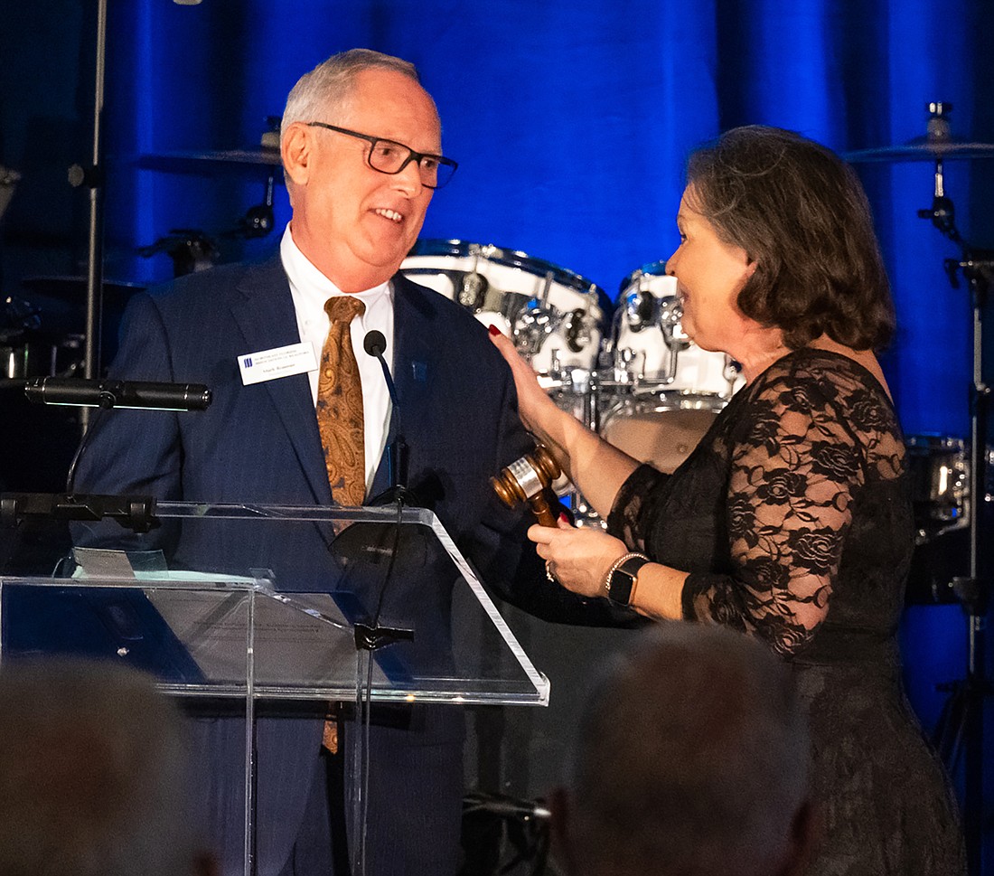 Mark Rosener, the 2022 Northeast Florida Association of Realtors president, is presented the gavel by his predecessor, Missi Howell. The 2022 Annual Installation and Awards Gala was Jan. 12. (Provided by NEFAR)
