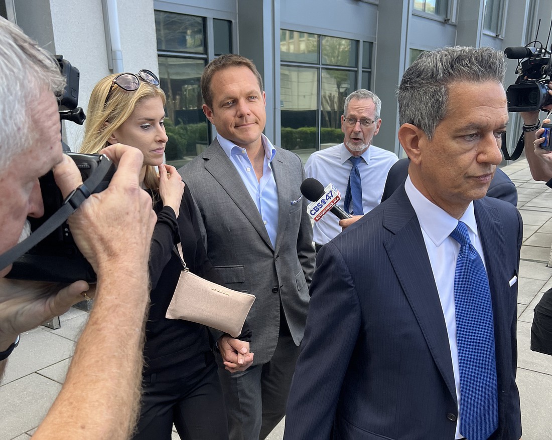 Former JEA CEO Aaron Zahn, back right, walks out of the Bryan Simpson U.S. Courthouse Downtown on March 8 with his wife and Attorney Eduardo A. Suarez after he pleaded not guilty to federal charges.