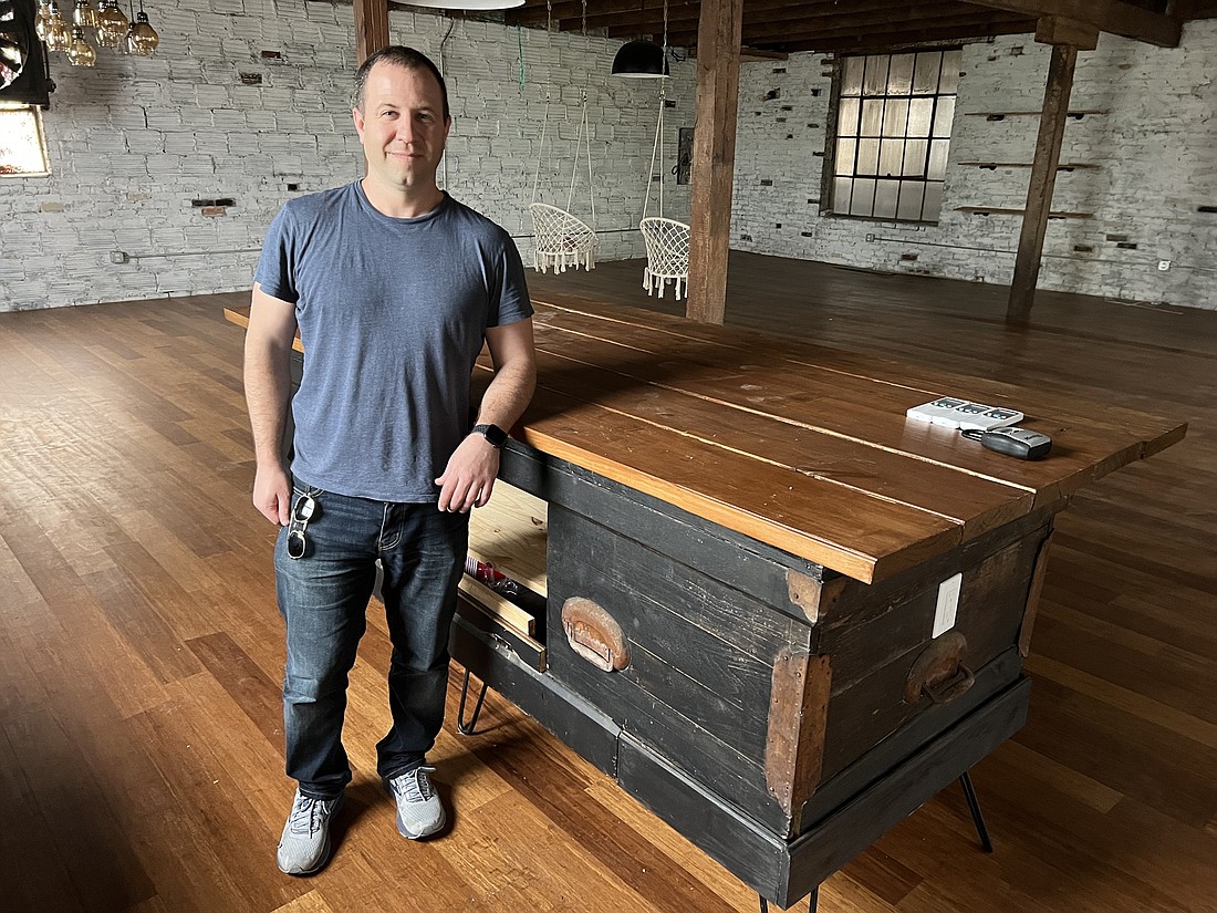 Photos by Dan Macdonald Eric Adler, owner of the Pratt Family Funeral Home in LaVilla, with a table made from a casket that he plans to include in the decor of his property as he transforms it into an Airbnb.