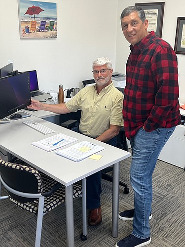 Bob Tedeschi (seated) and Paul Martinez found out the Boys & Girls Clubs of Northeast Florida received a $6.8 million grant when Tedeschi reacted after seeing it in the account.