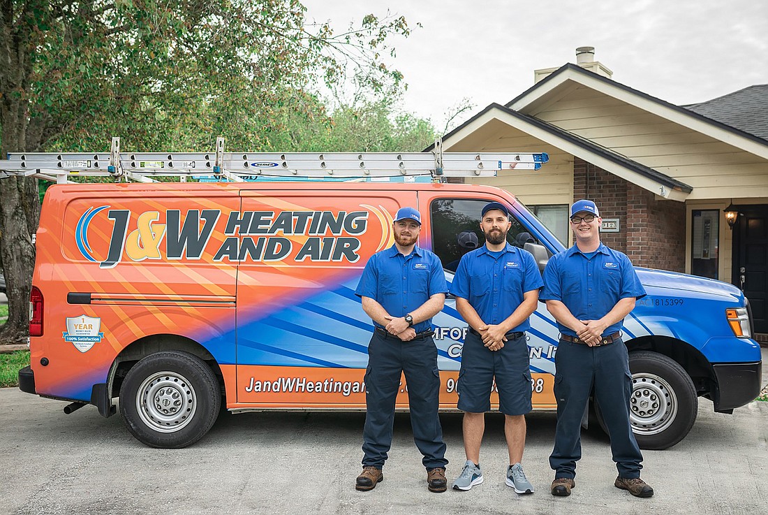 The J&W Heating and Air team at a project site.