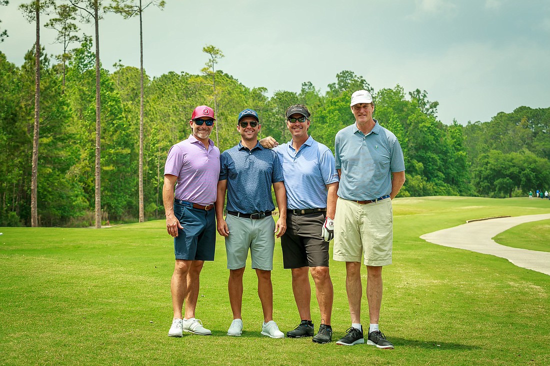 The Rogers Towers team finished in first place at the 2022 JBA Young Lawyers Section Chippinâ€™ in for Charity Golf Tournament. From left: Lewis Price, Mark Mitchell, Jason Hill and Jim Riley.