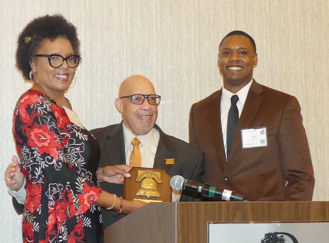 Rodney Hurst Sr., center, accepted the Jacksonville Bar Associationâ€™s 2022 Liberty Bell Award presented by Brenda Priestly Jackson and Malik Jackson.