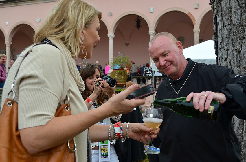 George Kehrt pours Jill Raleigh a glass of wine.