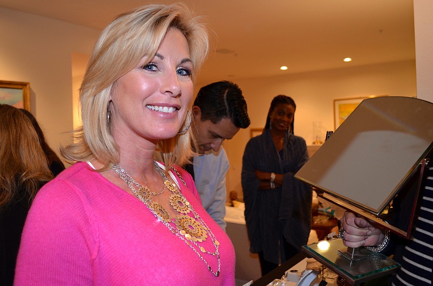 Jennifer Fox tries on a John Hardy necklace at the Blue Ties and Butterflies Preview Party.