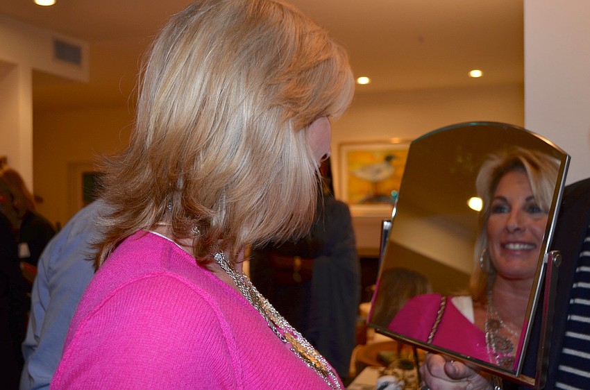 Jennifer Fox tries on a John Hardy necklace at the Blue Ties and Butterflies Preview Party.