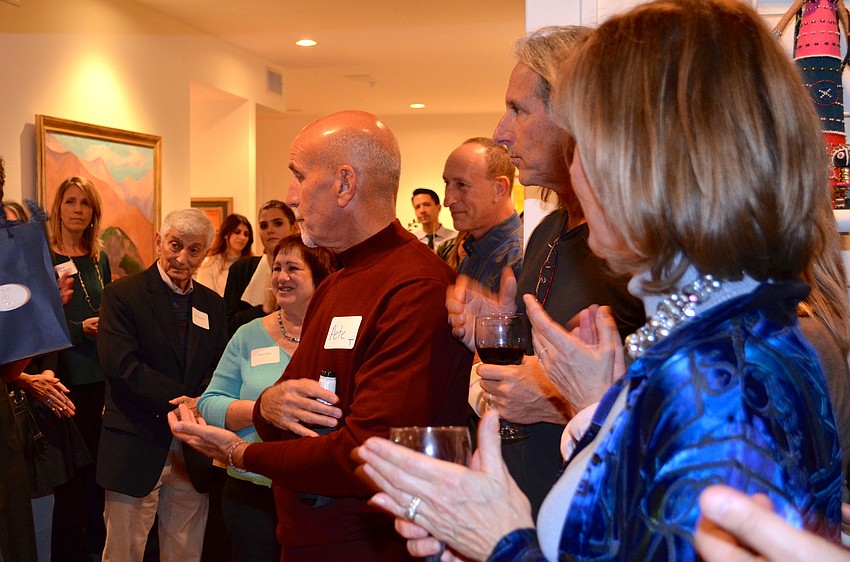 Guests look on as Child Protection Center executive director Douglas Staley talks about the organization and thanks everyone for their support.
