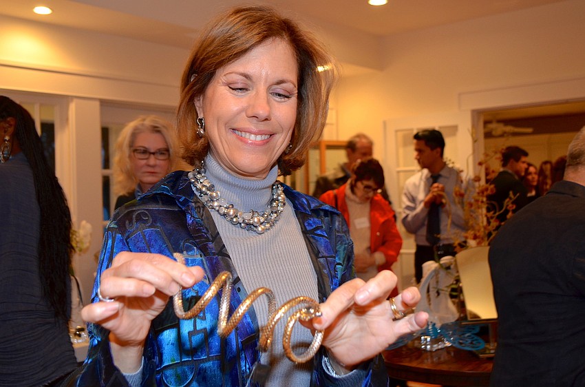 Jill Levine admires a John Hardy bracelet at the Blue Ties and Butterflies Preview Party.