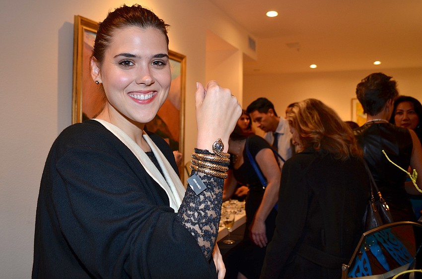 Emily Owen tries on a John Hardy bracelet at the Blue Ties and Butterflies Preview Party.
