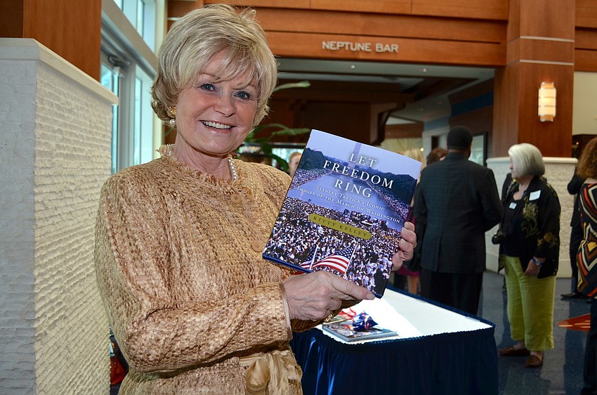 Kitty Kelley holds up her new book â€˜Let Freedom Ring: Stanley Tretickâ€™s Iconic Images of the March on Washington.â€™