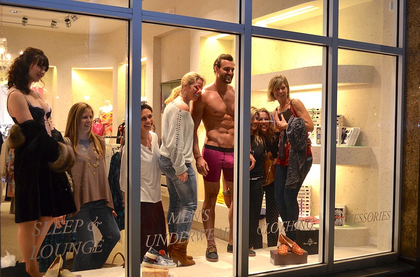 Shoppers decided to join the models in the window for a photo opportunity.