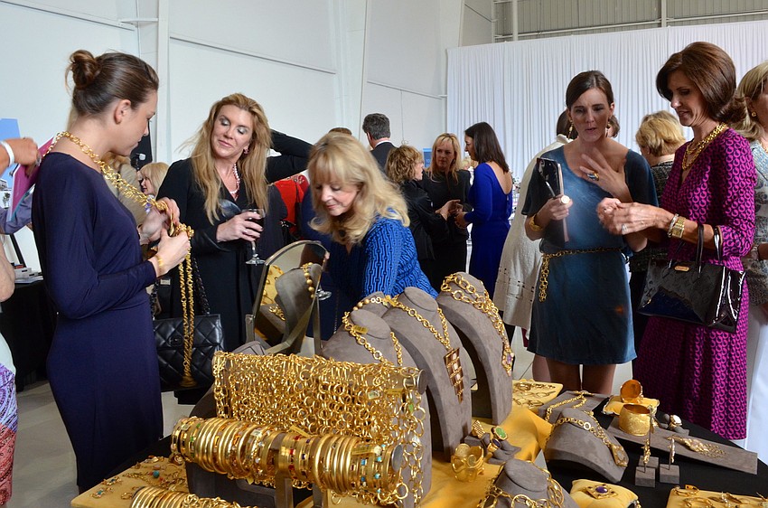 Guests at the 15th annual Sarasota Womenâ€™s Cancer Awareness Luncheon â€˜Cure on the Runwayâ€™ try on Stephanie Kantis jewelry from Saks Fifth Avenue Sarasota.