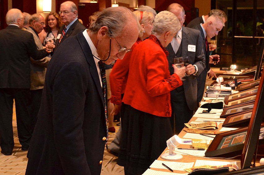 Guests at the Lincoln Day Dinner bid on items in the silent auction prior to being seated for dinner.