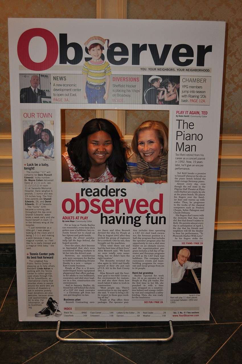 Zandy Sanders and Lisa Walsh pose together in the giant Observer front page cut out.