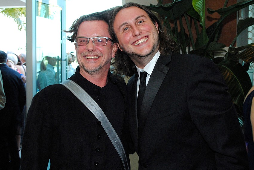 Jason Webb offers his dad Iain Webb some of his hair for the photo.