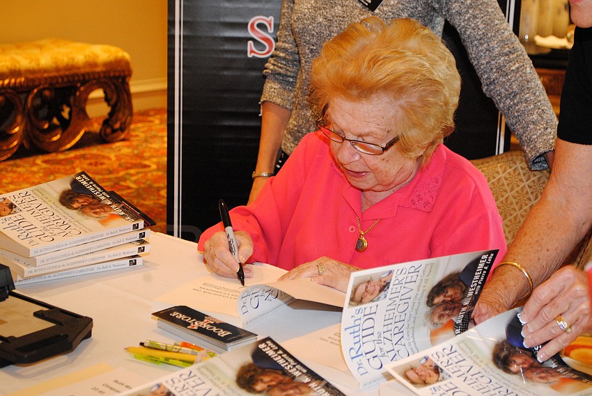 Featured guest Dr. Ruth Westheimer signs books for guests.