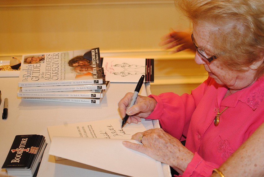 Featured guest Dr. Ruth Westheimer signs books for guests.