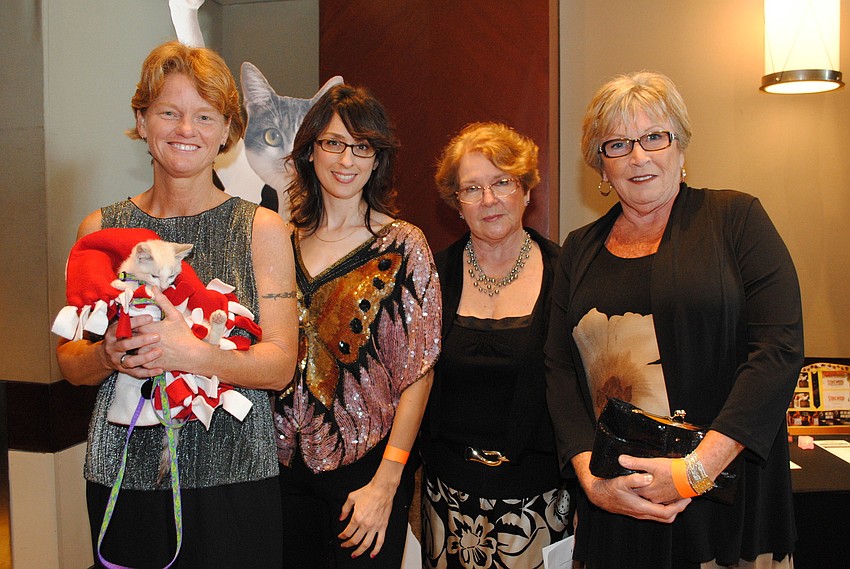 Deb DeVogt holding 11-week-old Rosie, Corey Roscoe, Cheryl Watts and Rosie Lizotte