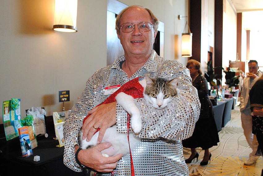 Peter Fender holding one of the cats rescued from the Napier Animal Sanctuary.