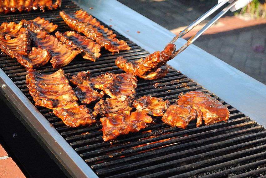Barbecue ribs were grilled on the patio at the â€˜Going for the Goldâ€™ Patron Party.