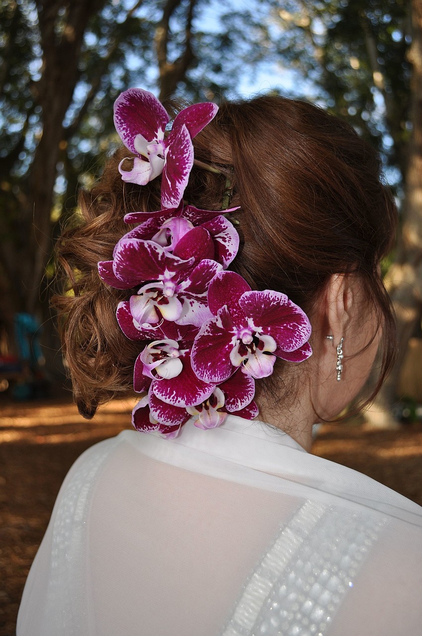 Debbie Seitl had her hair done up with orchids.