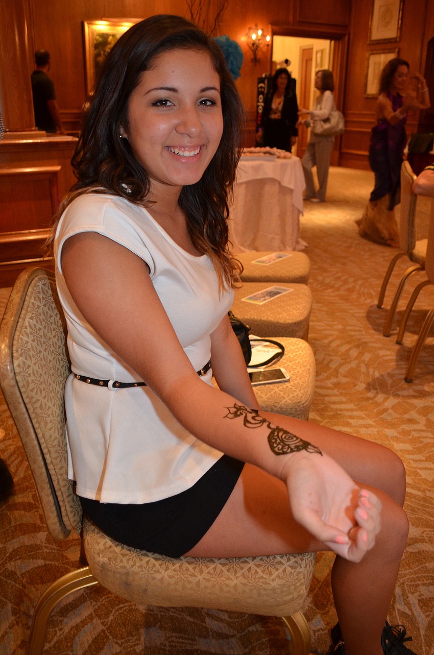 Stephanie Solorzano waits for her Henna tattoo to dry at the Hair of the Dog charity event.