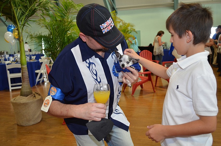 Richard Heatherington introduces LuLu the Chihuahua to Garrett Sennott.