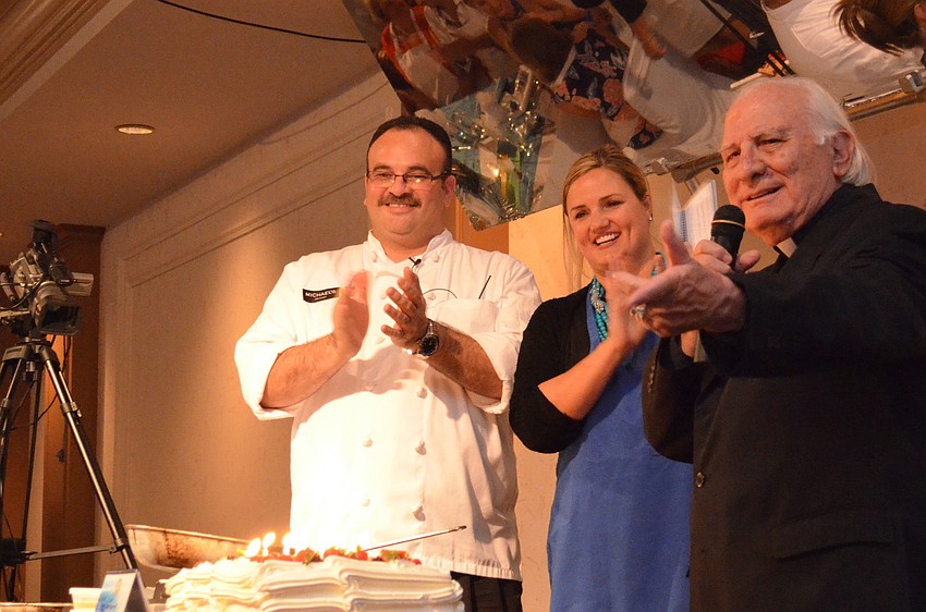 Jamil Pineda and Rebecca Blitz join Fr. Fausto Stampiglia in applause recognizing St. Marthaâ€™s newest priest Fr. Sebastian Szczawinski.