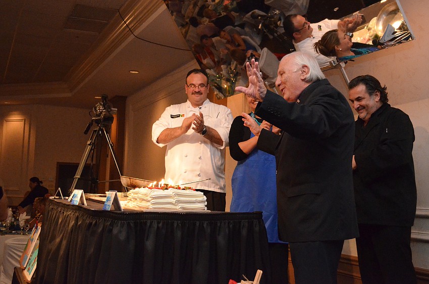 Fr. Fausto Stampiglia thanks everyone for surprising him with a birthday cake at the interactive dinner.
