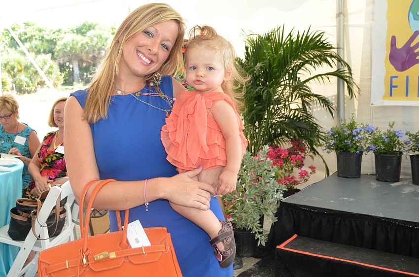 Samantha Kinglsey models in the Flip Flops Fashion Show with her daughter.