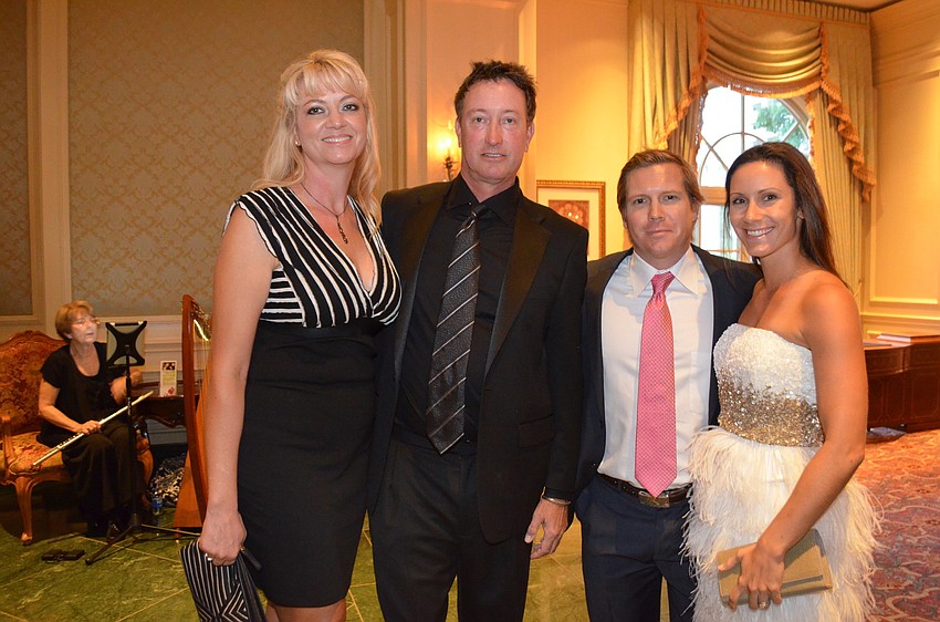 Michelle Qualley and Scott Lancaster with James and Christy Uihlein