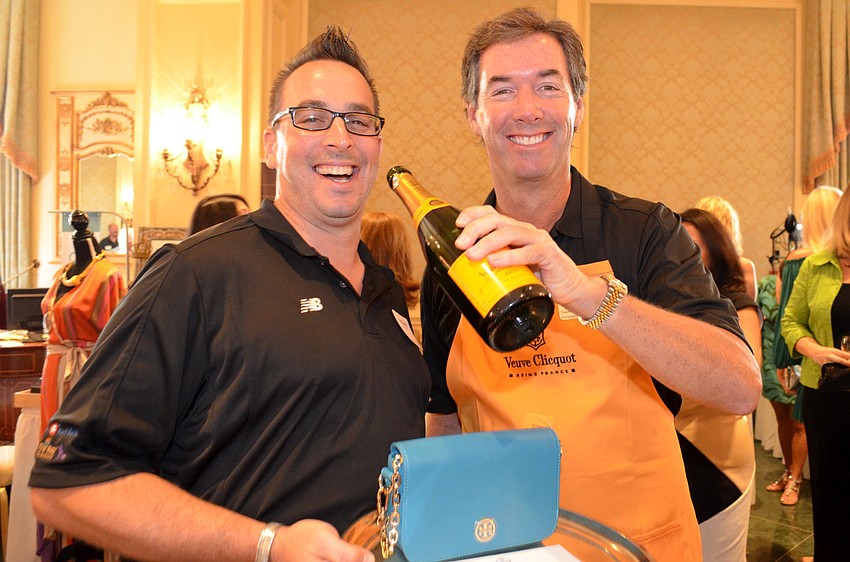 Sole Men Tim Beury and Ray Collins serve up some champagne at Wine, Women and Shoes.