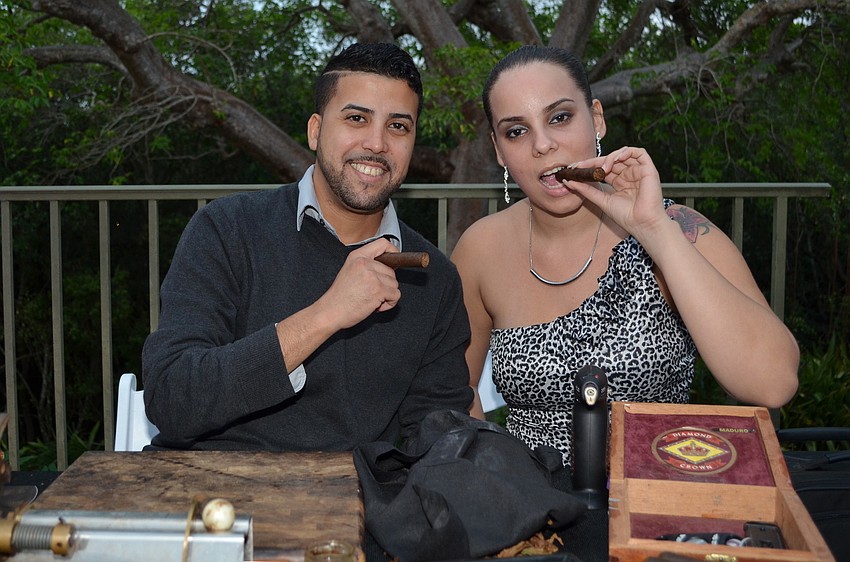 Ernesto Ceijas and Diana Batista roll handmade cigars for guests at Havana Nights and White Lights.