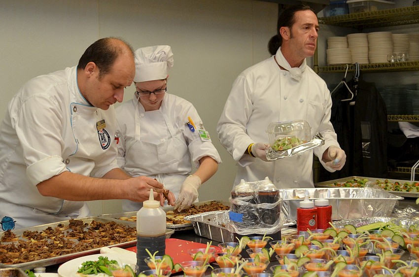 USF Sarasota-Manatee students prepare food for HospitaBull Evening Tuesday, Dec. 3, at Michaelâ€™s On East.