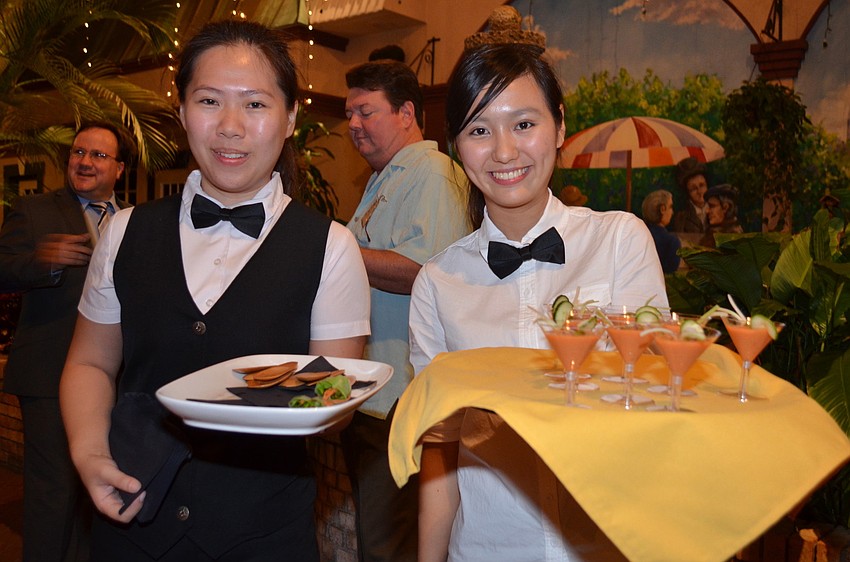 Nicole Lyuwanling and Rebecca Chin offer guests vegetable spring rolls and gazpacho shooters.