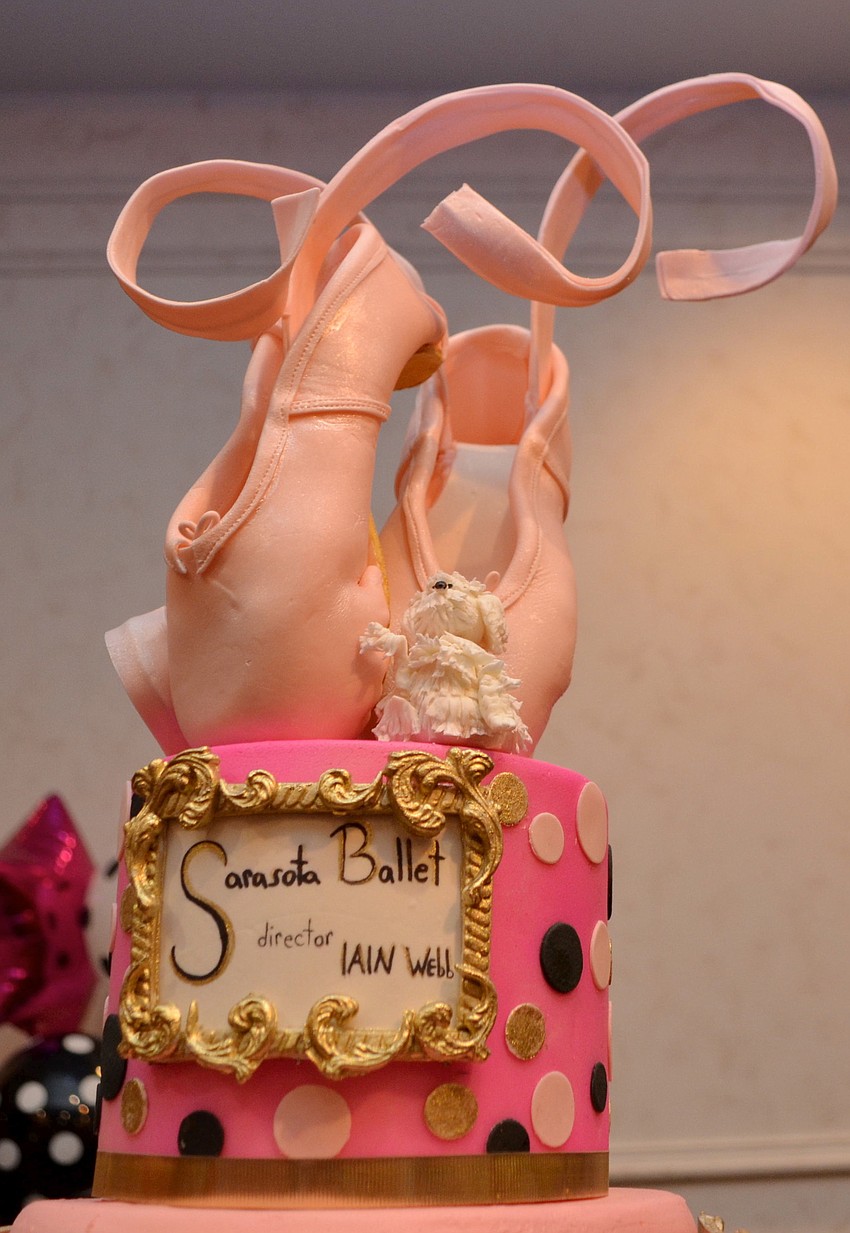 The cake for the celebration was topped with ballet slippers.