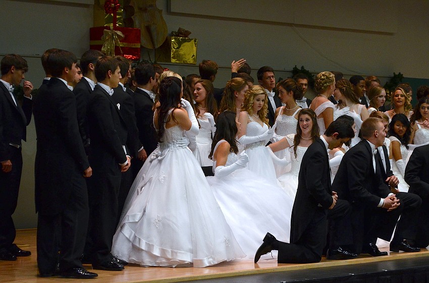 The debutants and their escorts get ready to pose for group photos.
